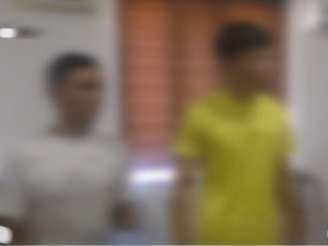 Two men detained for blackmailing a woman over intimate photos